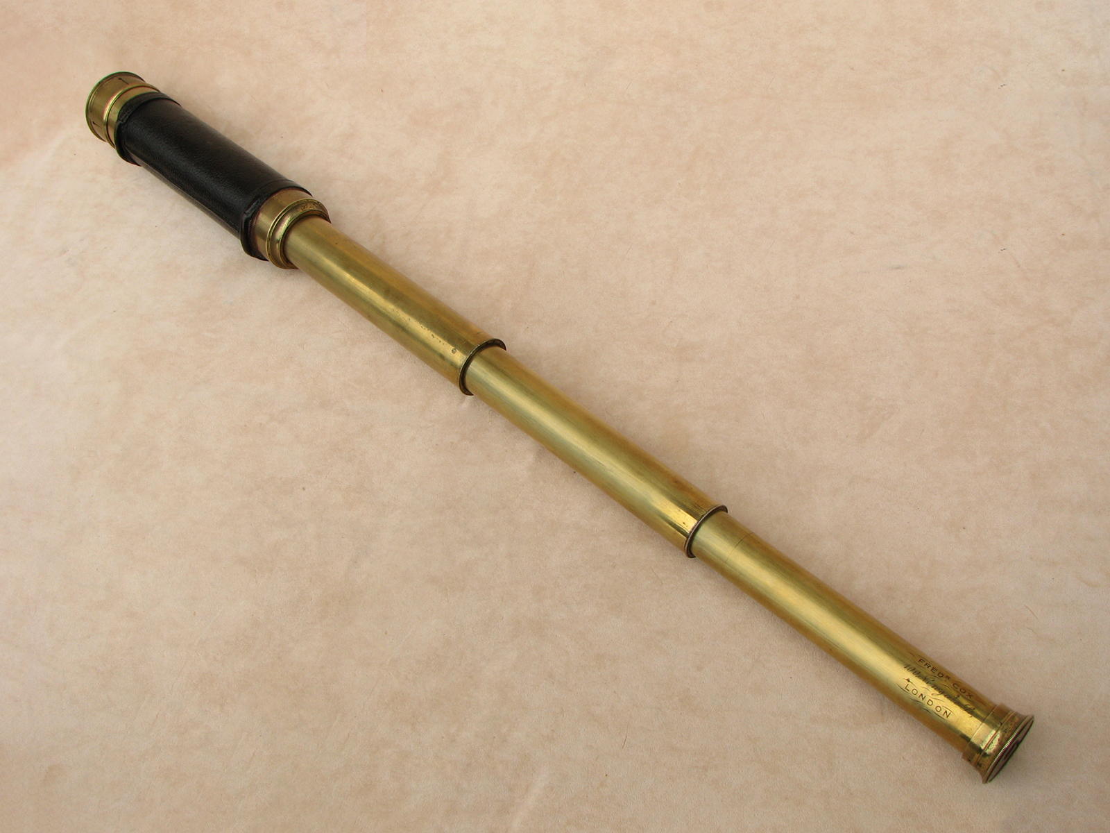 Frederick Cox mid 19th century 3 draw leather clad marine telescope.